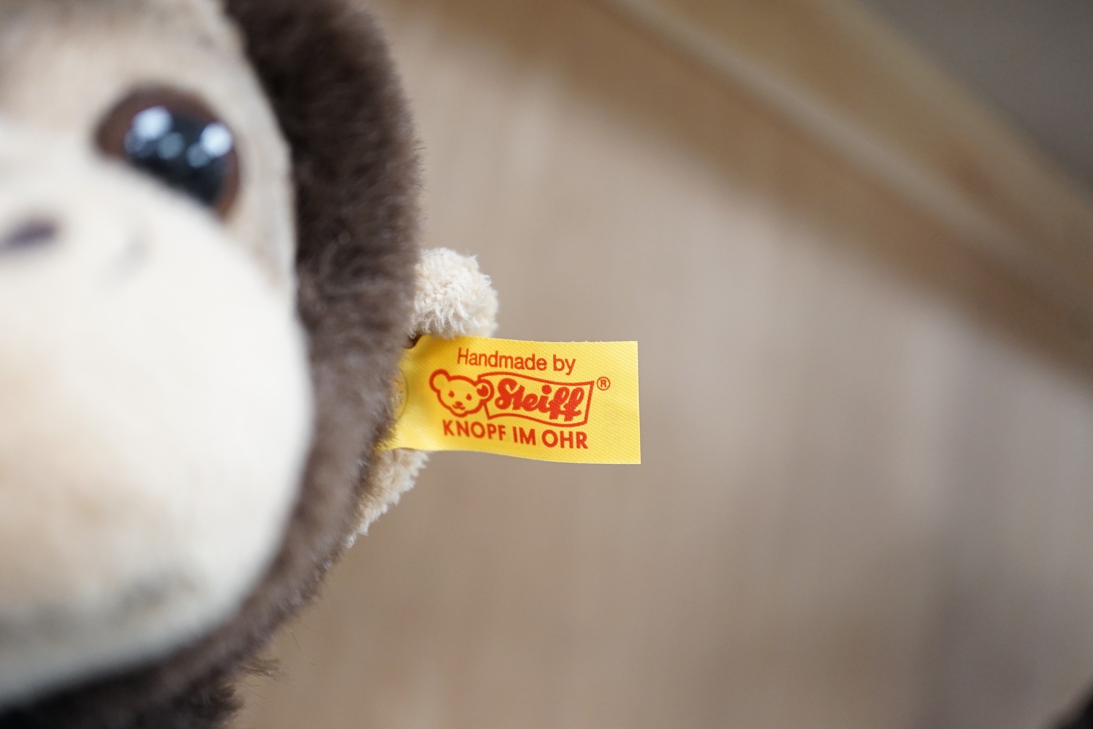 Three boxed Steiff toys: a Paddington bear, a brown bear and a monkey